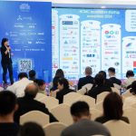 Ms. Truc Phan standing on stage, presenting key insights on Resolution 98 and its impact on Vietnam’s innovation ecosystem.